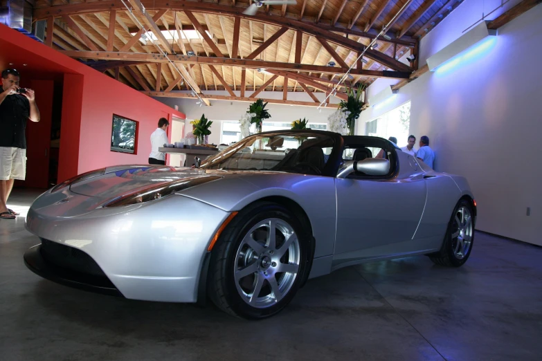 a silver sports car in an indoor parking lot