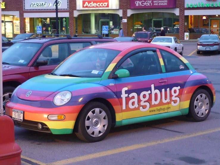 a multi - colored car that has a sign on the door
