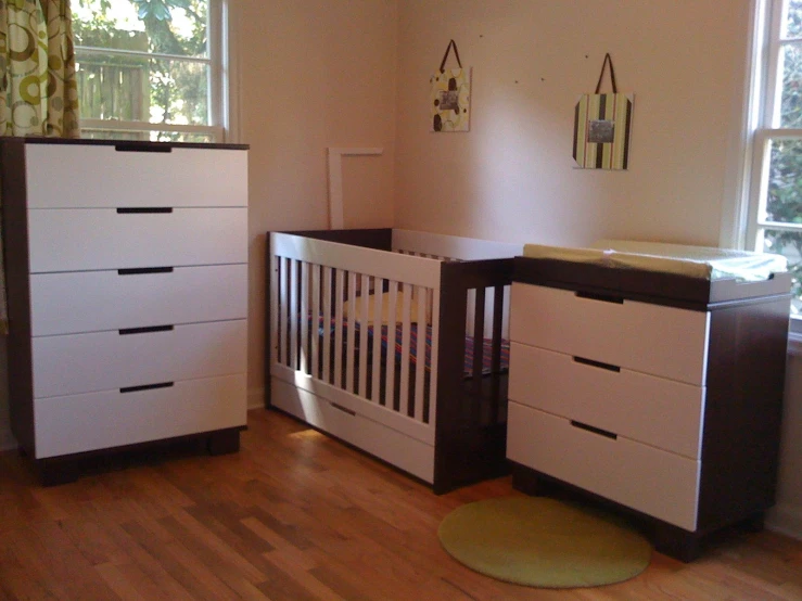 the large dresser is located near a crib