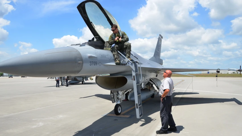 a fighter jet sitting on top of an airport tarmac