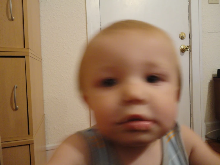 a toddler who is looking at the camera