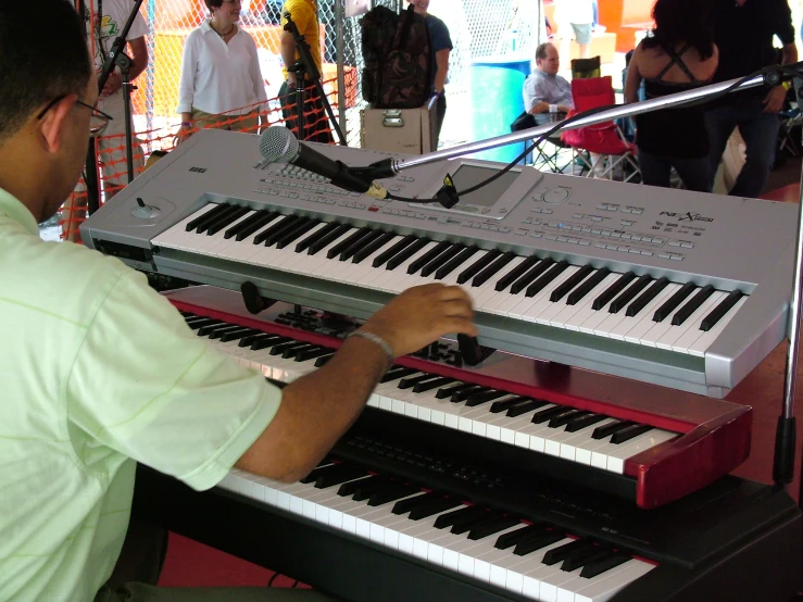 a man is playing piano on stage at an event