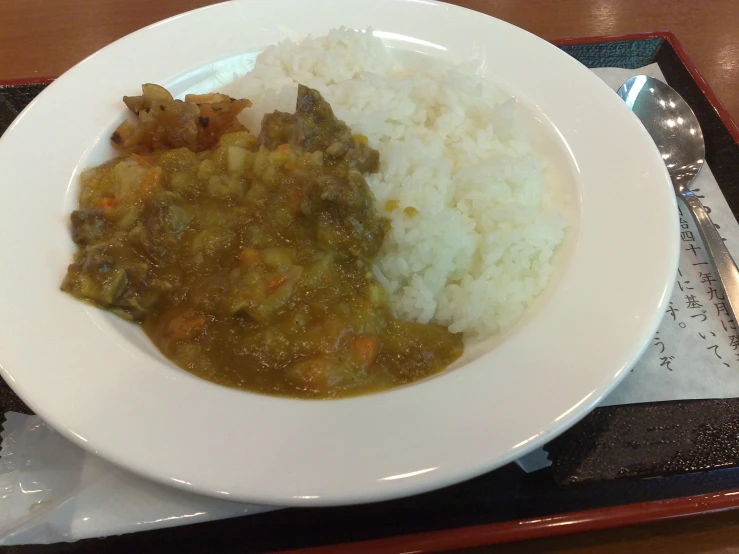 the white plate has rice and vegetables on it