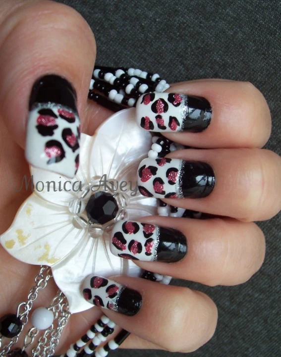 a female with a black and white manicure with leopard print