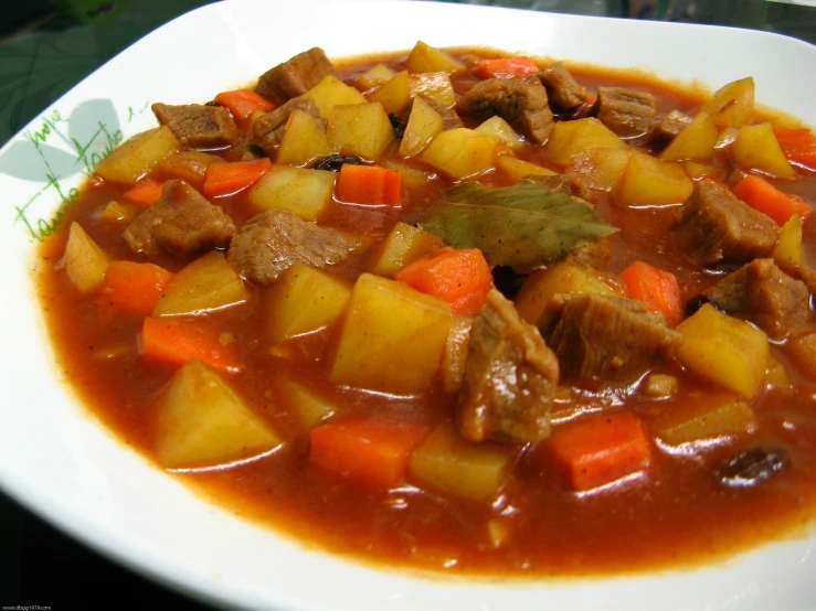 a bowl of stew is sitting on the table