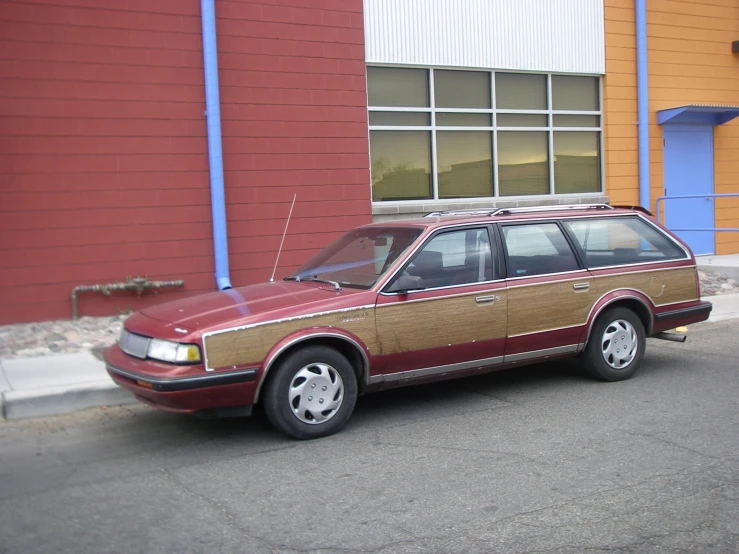 a red wagon parked in front of a building