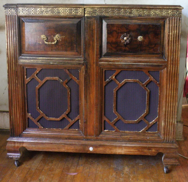 a decorative wood cabinet is on wheels in the room