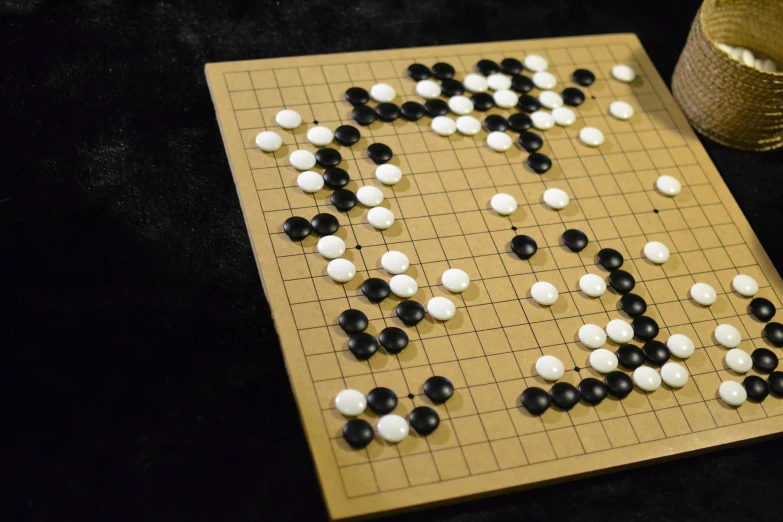 a game board and dice with pieces of black and white and brown