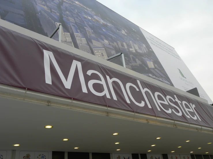 there is a marquee sign on a building that reads manchester