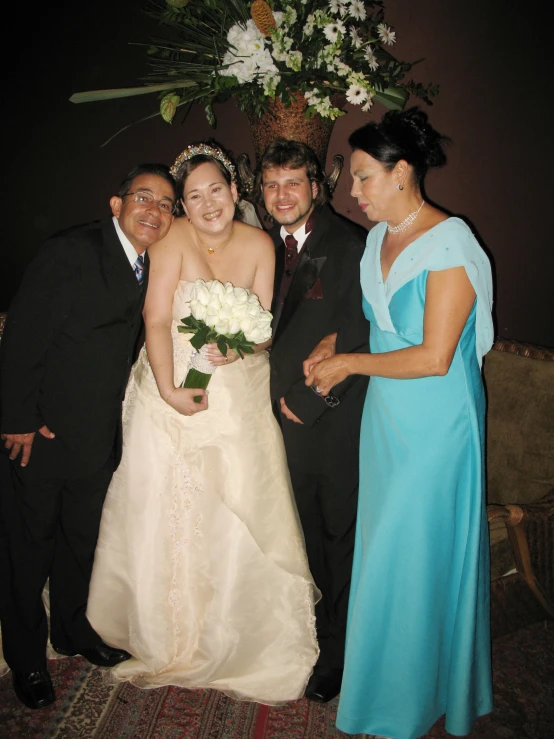 a bride and groom are standing next to their friends