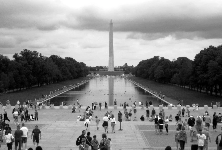 a very large group of people that are by a fountain