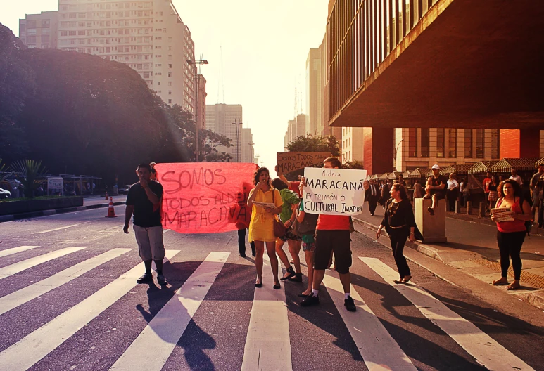 group of people walking down street with protest signs