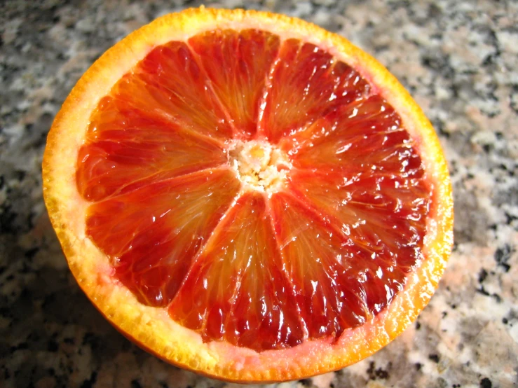 the  orange is sliced in half on the counter