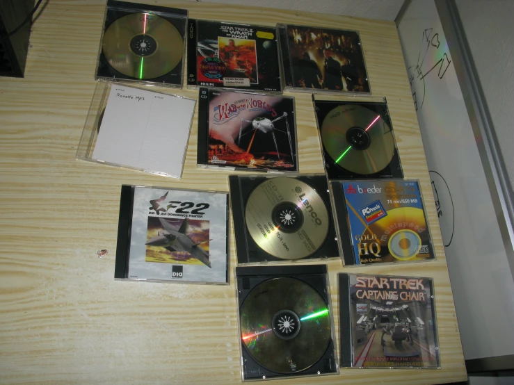 several cds sit next to a plastic bag