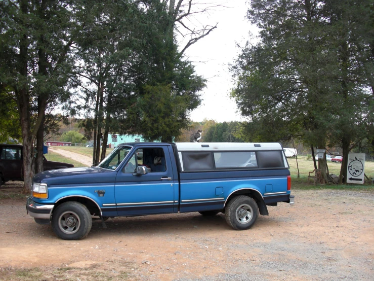 there is a truck that is parked on the gravel