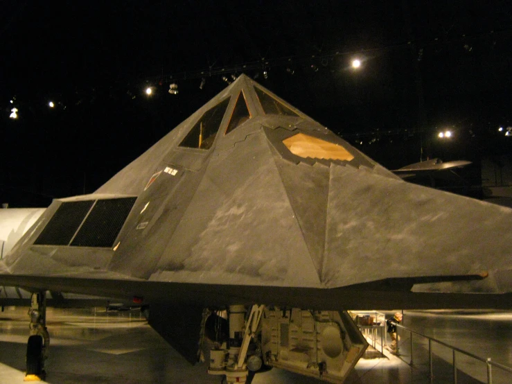 a jet parked on the tarmac at night