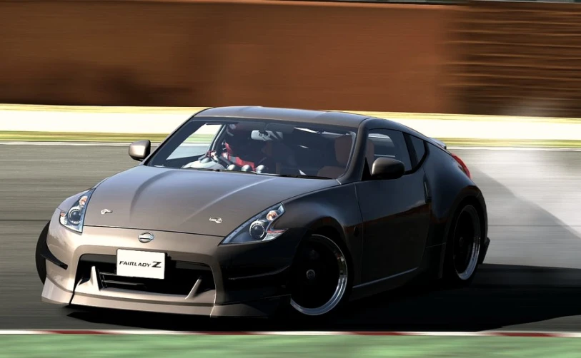 a nissan sports car driving down a track