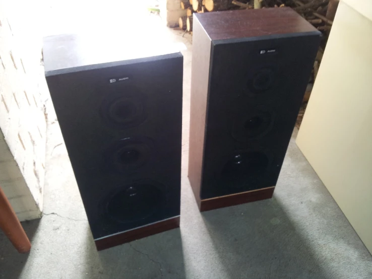 two speakers sitting on the floor side by side