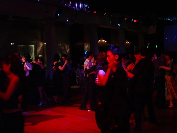 group of people dancing at night in club