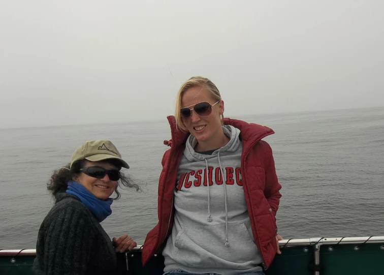 a couple of women are sitting together on a boat