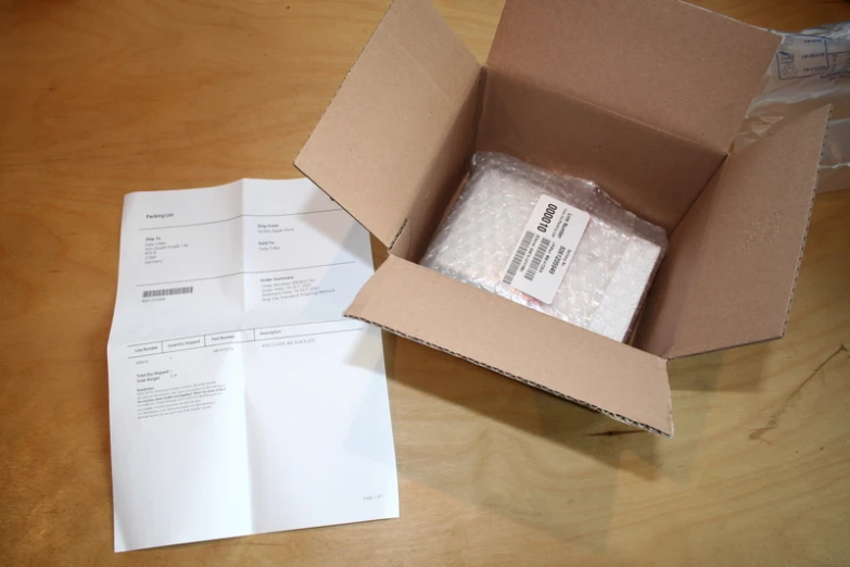 a box sitting on top of a wooden table filled with papers