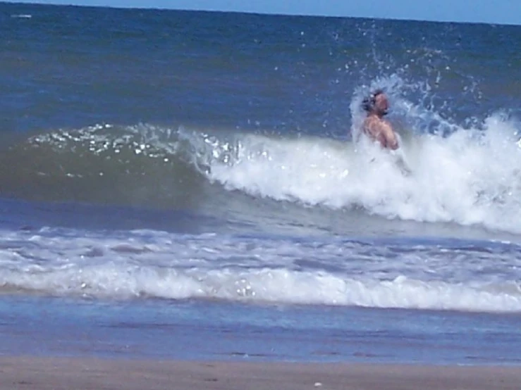 a man surfing a small wave in the ocean