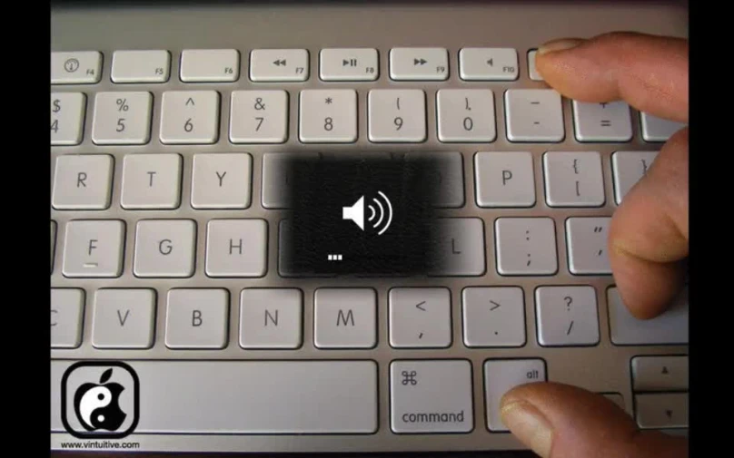 a person touching a black on on top of a keyboard