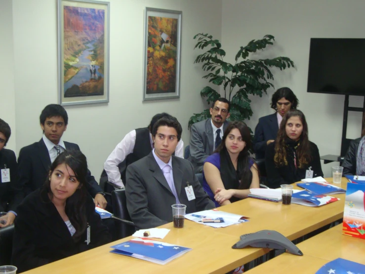 a group of people sitting around a table at a meeting