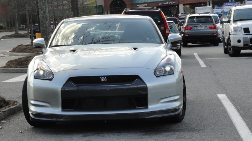 a silver car that is parked in the street