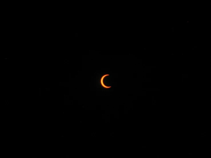 a solar eclipse seen through the darkness from an airplane