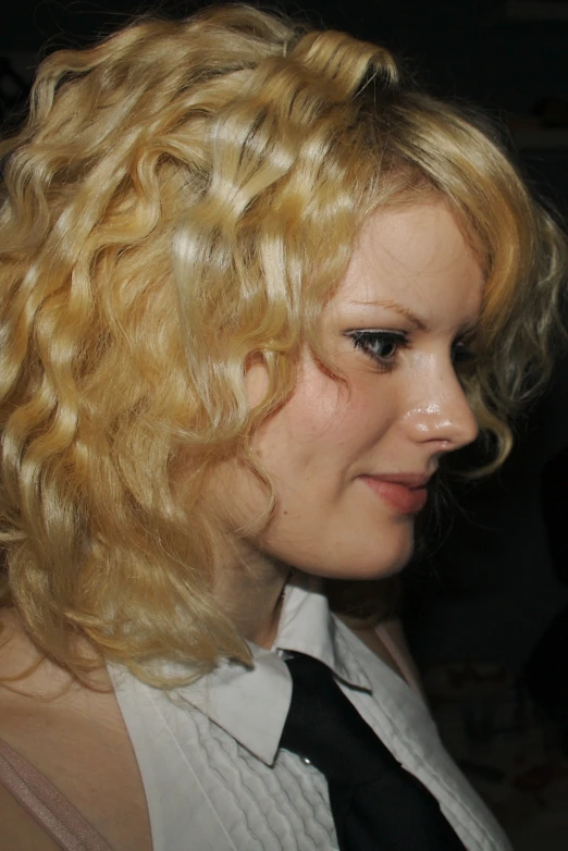 a woman wearing a tie and blonde hair