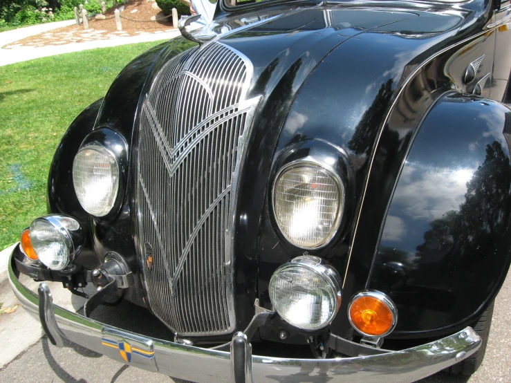 there is a large black old style car that is parked