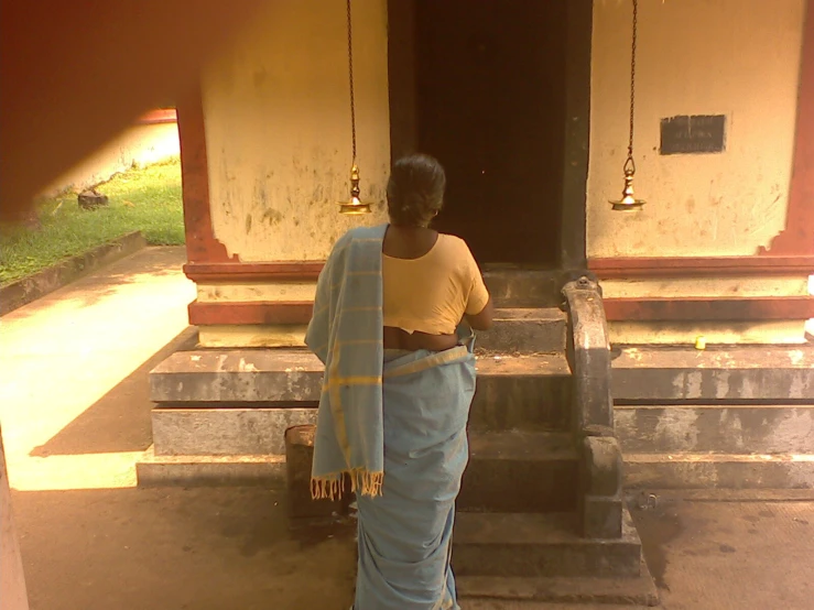 woman in blue and white clothing looking down