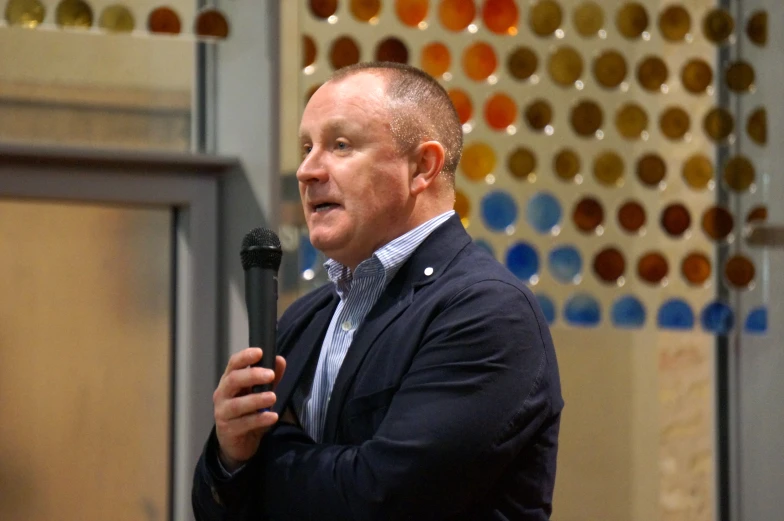 a man holding a microphone at a podium