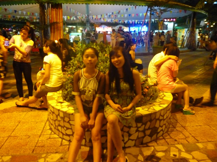 two s sitting on top of a stone bench