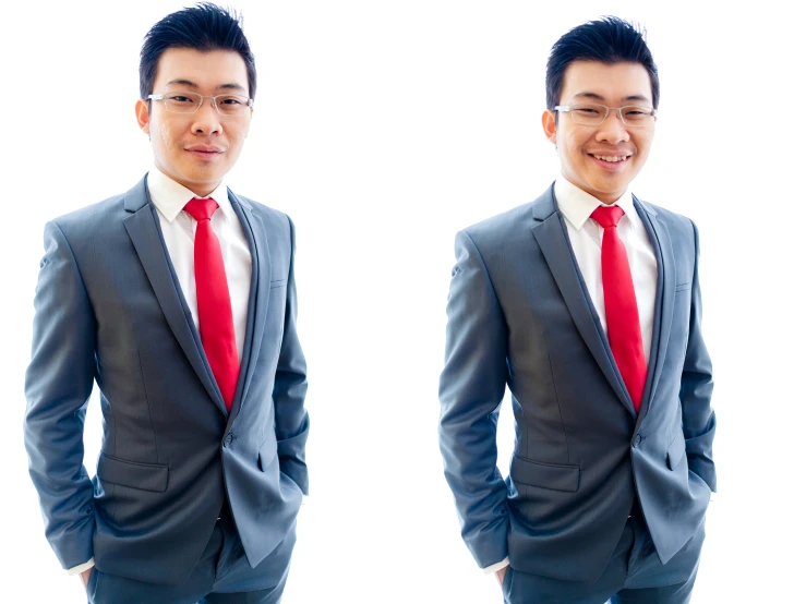 a young man in glasses and a gray suit and red tie