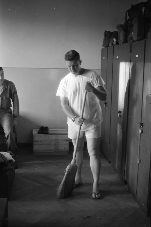 two men in the process of doing tricks in an empty room