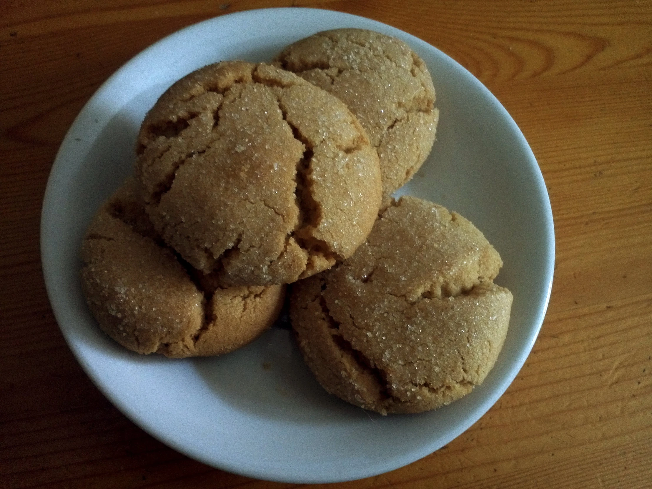 small, brown sugar cookies on a white plate