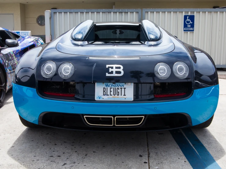 a very fancy blue bugatti car on a parking lot