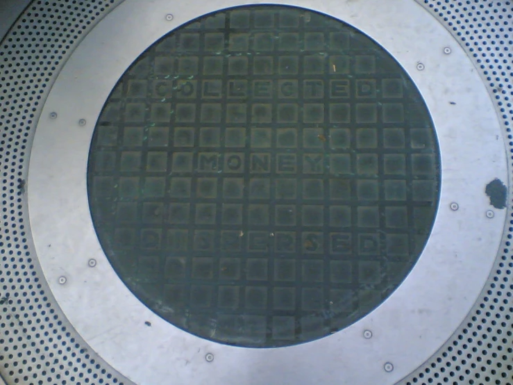 the manhole of a large round metal structure with holes