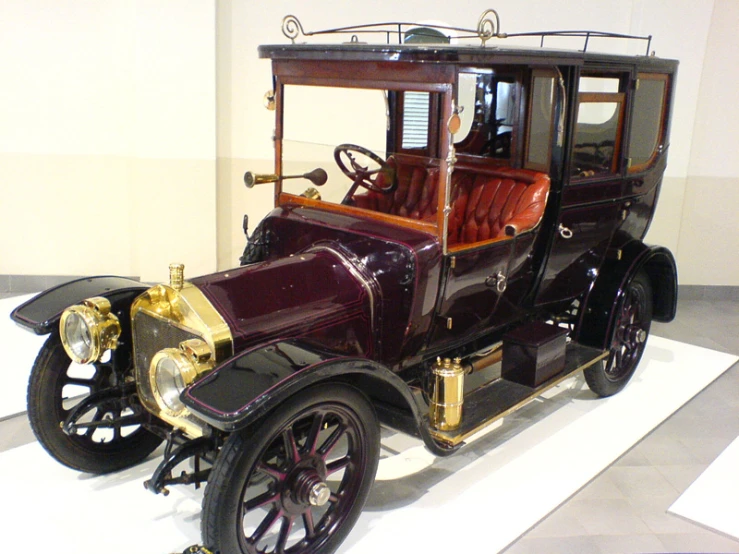 an old style car on display in a museum