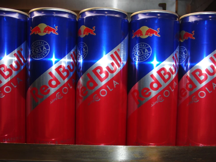 several red bull cans lined up on display