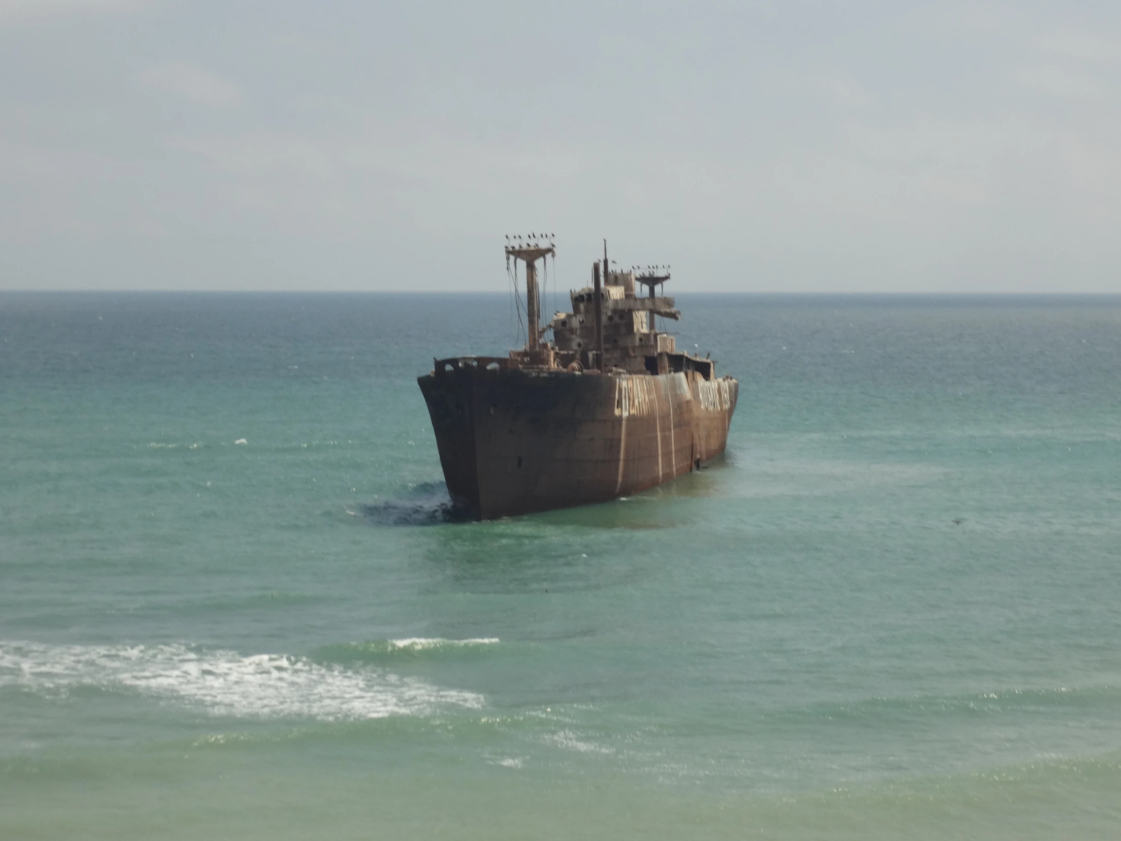 an old rusty boat floating in the water