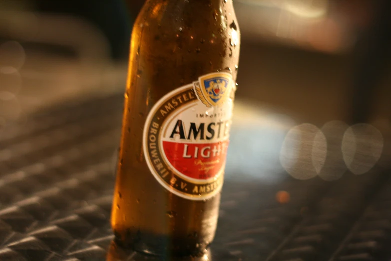 a bottle of amsl beer sits on a table