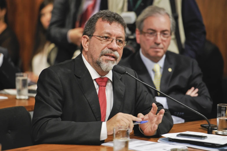 a man in a suit is sitting at a table