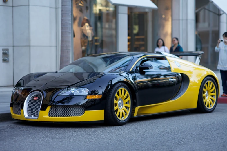 an exotic automobile on the street is parked in front of a store