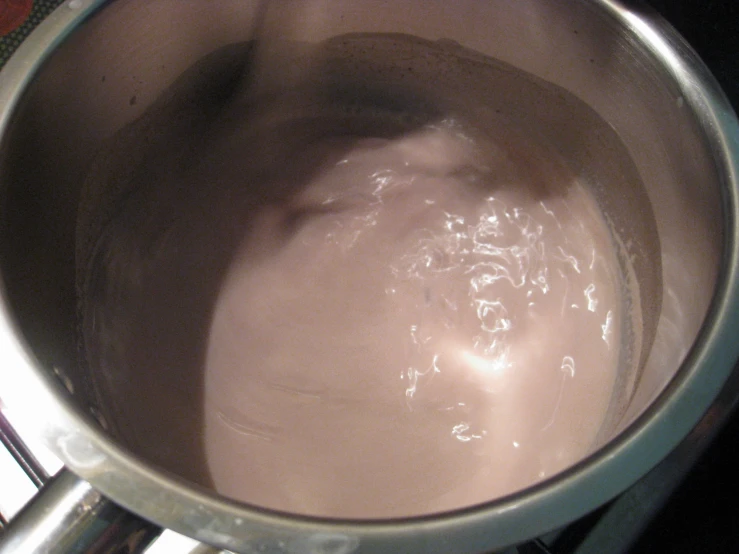 a silver pot with water boiling inside of it