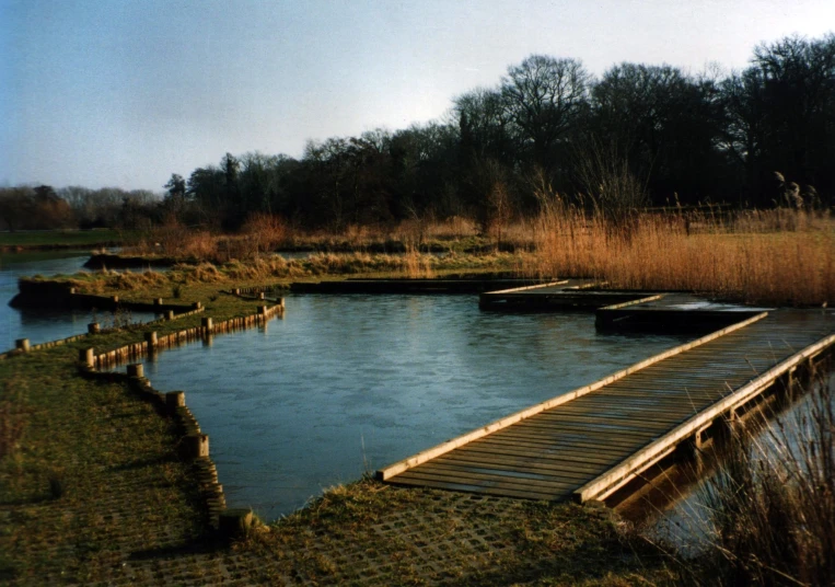 a bridge crossing over water on the side of a hill