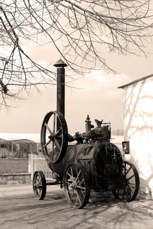 an old locomotive sits parked on a dusty lot