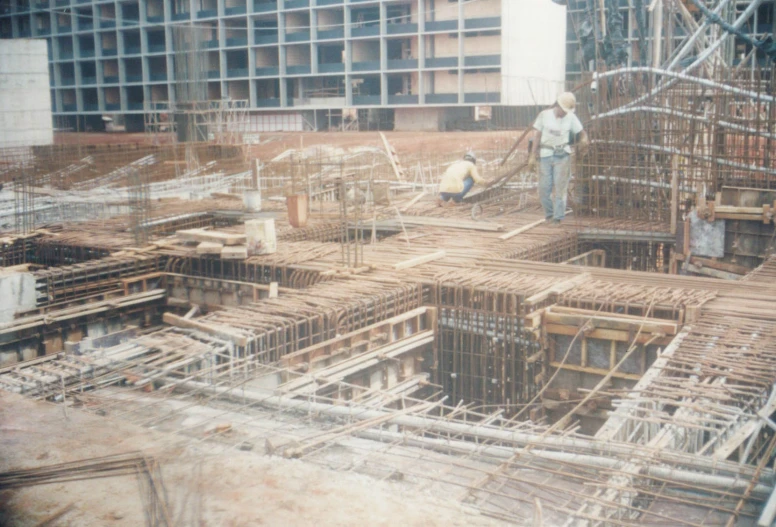 a construction worker standing in the middle of a large area of wood